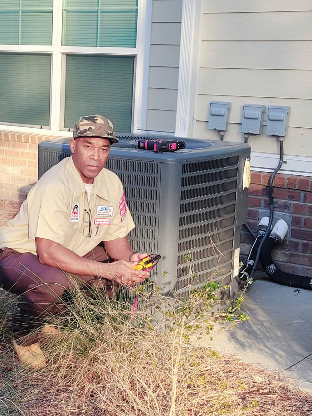 Dunell Do All technician servicing a condenser unit